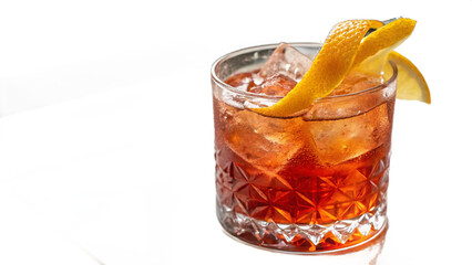 Classic bar drink featuring amber hues, lemon wedge garnish, and textured old-fashioned glass with clear ice cubes.