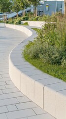 Obraz premium Modern landscaping design showcasing a curved concrete border filled with lush green plants, creating a visually appealing and inviting urban space