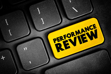 Fototapeta premium Performance Review - formal assessment in which a manager evaluates an employee's work performance, text concept button on keyboard