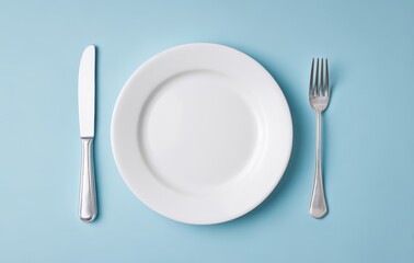 a white plate, knife, and fork on a light blue background