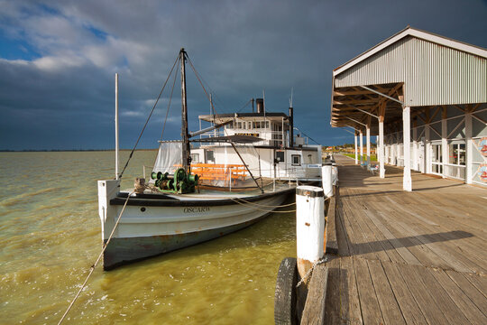 A paddle steamer beside a wharf