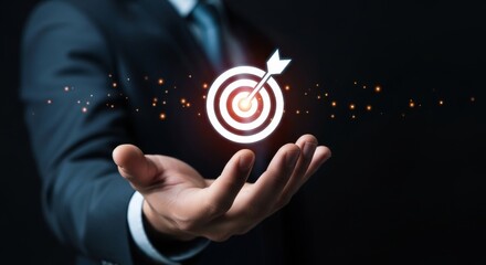 Businessman presenting glowing holographic target icon in hand, symbolizing business strategy, goal achievement, customer focus, and marketing growth planning