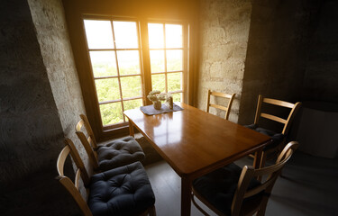 Room with stone walls and sunlight through vintage window.