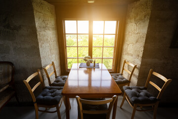 Room with stone walls and sunlight through vintage window.