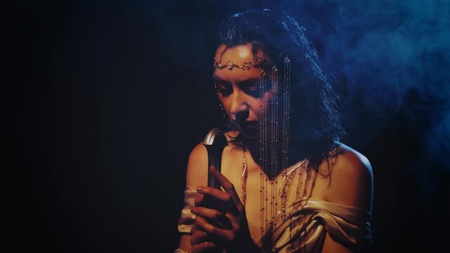 fantasy woman queen queen praying hands folded in prayer holding sword girl kneeling in dark room castle looking at ray of light hope. Black night white dress. Elf girl warrior on knees. sharp blade