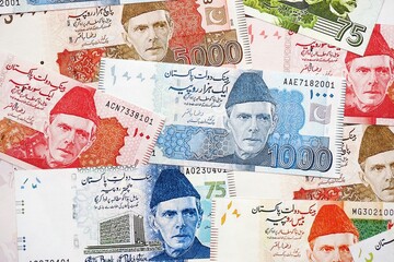 Pakistan rupees banknotes. The current Pakistan money bills lies on table in big amount