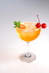 Fruity alcoholic cocktails with lemon, lime, or orange slices in a glass with ice