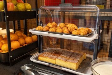 Delicious croissants and pastries waiting on buffet table for breakfast