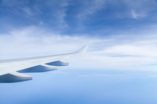 Plane wing over coastal Australian waters on long distance flight