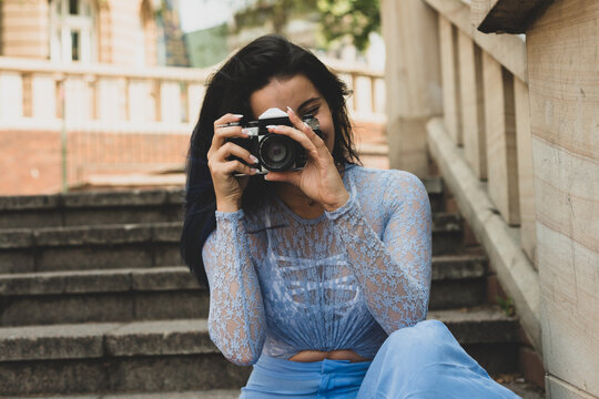 young woman with film camera