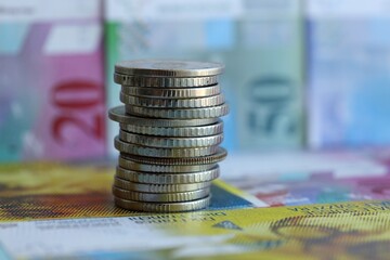 Swiss franc banknotes and coins. The current francs money bills and coins lies in big amount