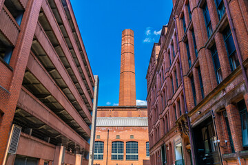 A view down a side street towards an old mill  in Manchester,UK in summertime