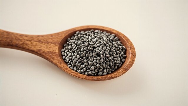 Spoonful of black and white chia seeds on wood