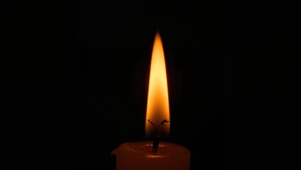 Isolated candlelight flicker on a black backdrop