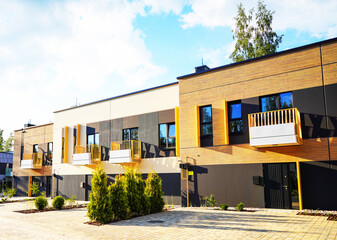 Modern townhome design. Modern townhouse yellow facade building exterior. Modern two-story house...