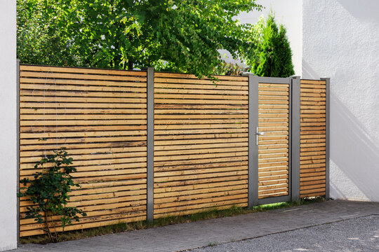 Wicket Gate of Wood Fence of Residential House. Wooden Fence of Horizontal Wood Boards. Modern Garden Gate.