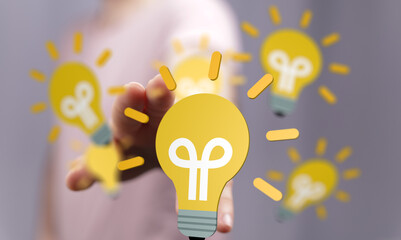 Person's fingertip selects a glowing lightbulb, symbolizing idea selection, innovation, and...