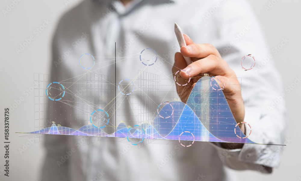 Poster stock photo of a businessman using a stylus to interact with projected data charts showing growth an