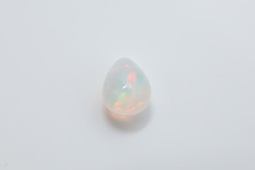 Glowing White Opal Gemstone with Rainbow Play of Color on White Background