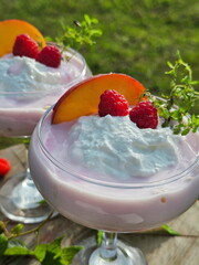 Dessert with peach, alina and yogurt in glass glasses