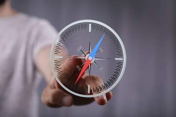 Person using a digital compass, showcasing navigation and direction. Ideal for business,...