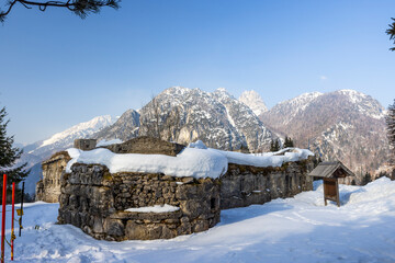 Ruins of Fort Hensel in Tarvisio covered by snow during winter with Julian Alps in background