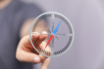 Person using a digital compass for navigation.  Modern technology, direction, guidance.