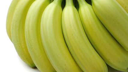 Bunch of unripe bananas against a plain white backdrop