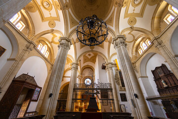 Interior of Santa Maria Square Cathedral showing columns, arches and chandelier in Baeza, Spain