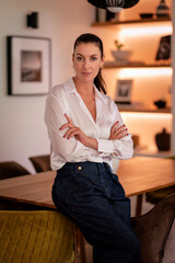 Confident middle aged portrait in her modern home
