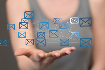 Hand holding network of email icons. Digital communication, global network, and email marketing concept.