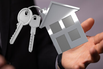 Image of a realtor presenting house keys and a home keyring. Perfect for real estate, property, and...
