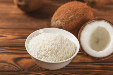 Set of fresh whole and half coconuts and slices on wooden background. Coconut flakes. Vegan. Tropical nut, fruit. Place for text. Copy space.