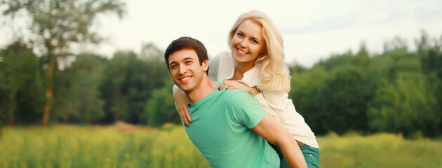 Fototapeta premium Portrait of beautiful happy smiling young couple in love together hugging in summer park