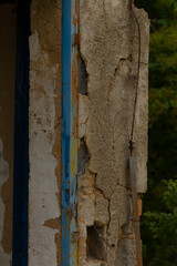 A very old building that features peeling paint throughout and has a charming blue trim along its edges, adding character to its appearance