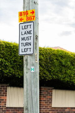 Left Lane must turn left sign on power pole with 816 and 867 arrow signs