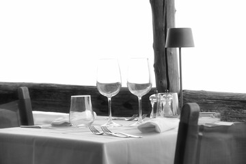 A seaside restaurant table set for a romantic dinner on the Ligurian coast of Spotorno on a summer day in 2025.