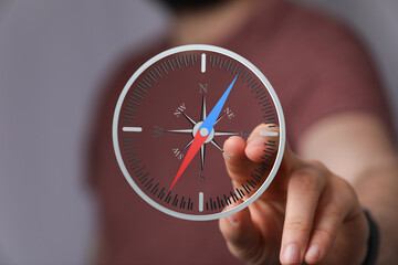 A man interacts with a digital compass, finding direction and guidance.  Perfect for business,...