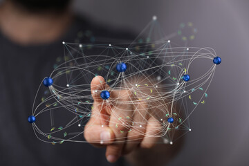 Hand interacting with a digital network, illustrating global connectivity and data flow.