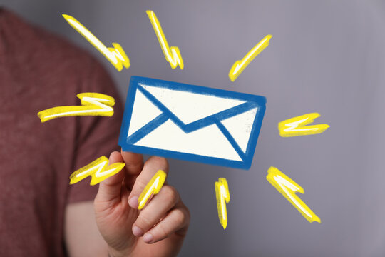 Hand holding digital email icon, signifying new message.  Bright, modern design.