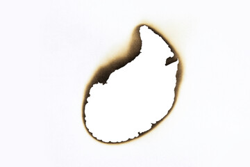 Abstract burnt hole in white paper with detailed scorched edges. A vintage grunge texture element perfect as a frame or for a damaged effect design, isolated on white background with clipping path.