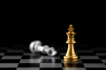 Gold chess king achieves victory over a fallen silver king. A powerful business concept of...
