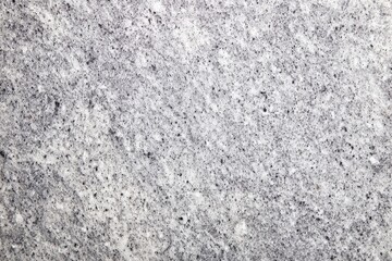 Obraz premium Light gray textured background with random dark spots and a swirly texture