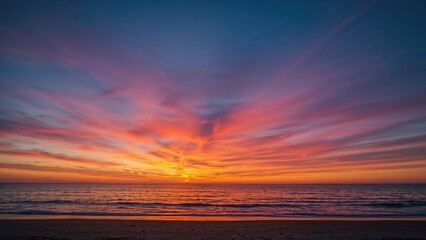 Obraz premium Vibrant shades from a beautiful sunset illuminate the calm beach, showcasing nature's stunning artistry.
