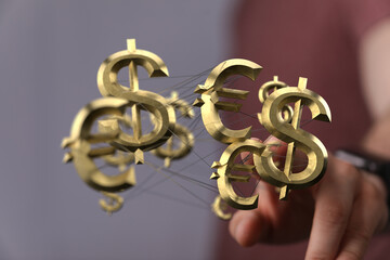 Image depicting interconnected golden dollar and euro symbols, representing global finance and...