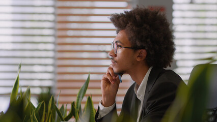 Pensive dream thoughtful African American man male business working corporate creative job work...