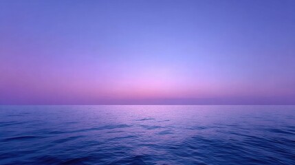 Obraz premium Serene Sunset Over Calm Ocean Water with Soft Purple and Blue Tones in the Sky and Reflection on the Surface