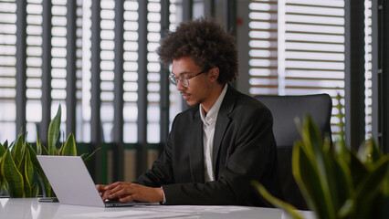 African American ethnic man business male using laptop typing online professional creative guy...
