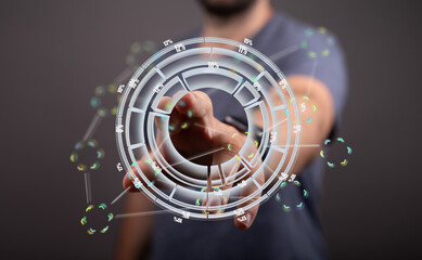 A person interacts with a holographic display showing data charts and percentages.