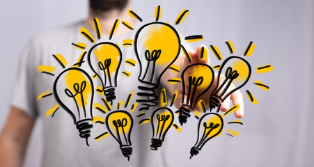 Hand holding multiple glowing light bulbs, symbolizing new ideas, innovation, and solutions.